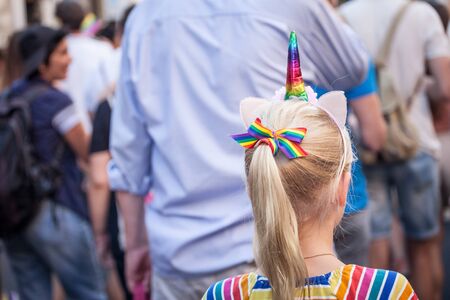 BELGRADE, SERBIA - SEPTEMBER 15, 2019:  Girl wearing a rainbow unicorn costume marching during the 2019 Belgrade Gay Pride. Unicorns are among the LGBTQ symbols

Picture of a girl seen from behind wearing a unicorn costume with rainbow colors , during theのeditorial素材
