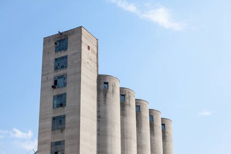 High Concrete Wheat Silo, old and abandoned, in an agricultural industry of Serbia, in Europe, with...