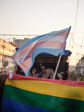 BELGRADE, SERBIA - SEPTEMBER 15, 2019:  Transgender pride flag waiving with the rainbow flag during the Belgrade Gat PrudeThe parade happened this year without trouble, under huge police watch. 

Picture of a crowd of people standing behind the transgendeのeditorial素材