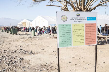 GEVGELIJA, MACEDONIA - DECEMBER 23, 2015: Sign indicating the entrance of Vinojug UNHCR camp near city of Eidomeni Idomeni in Greece on the border with macedonia, on Balkans Route, during Refugee Crisis

Picture of asylum seekers standing at the entrance のeditorial素材