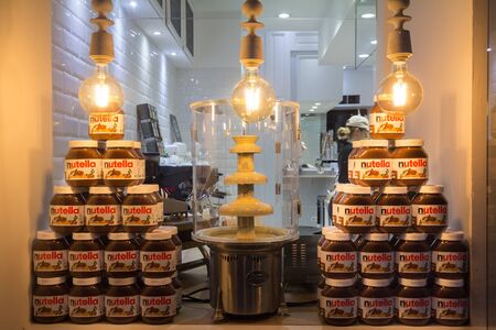 VIENNA, AUSTRIA - NOVEMBER 6, 2019: Nutella Jars piled with their logo on display in a retailer in Vienna. Nutella is a hazelnut and cocoa spread produced by the italian industrial Ferrero.

Picture of a bunch of Nutella jars piled up in the window of a lのeditorial素材