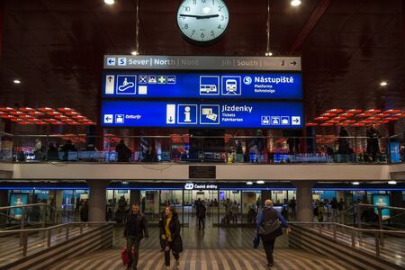 PRAGUE, CZECHIA - OCTOBER 31, 2019: Ticket counter and booth of Ceske Drahy, the Czech railways, in the Praha Hlavni Nadrazi train station with passengers passing and rushing.Picture of passengers passing by in front of the ticket office of Ceske Drahy,のeditorial素材