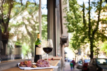 slices of baguette bread, brie cheese and saucisson (a cured meat from France) for appetizers with a...