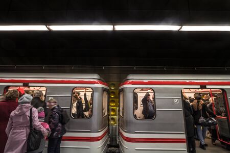 PRAGUE, CZECHIA - NOVEMBER 2, 2019: Passengers rushing to enter a crowded train in the Prague Metro (Prazske Metro) during peak hour. It is the main rapid transit system in the city.Picture of a metro train  in a subway station of Prague, Czech Republicのeditorial素材