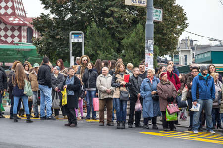 BELGRADE, SERBIA - NOVEMBER 1, 2014: Crowd packing waiting for a buson the stop of Zeleni venac terminal, one of the main hub of Belgrade GSP, the public transportation system of the city.picture of a crowd of people waiting to board an urban bus in Belのeditorial素材