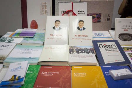 BELGRADE, SERBIA - OCTOBER 25, 2019: Propaganda books, mainly the book of Chinese President Xi Jiping, Governance of China, for sale on a bookstore shelf selling Chinese propaganda communication.Picture of a group of chinese books translated in English,のeditorial素材