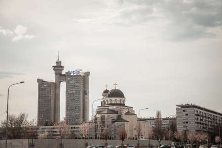 BELGRADE, SERBIA - MARCH 30, 2018: Skyline of Novi beograd with the Western Gate, also called Zapadna Kapija, or Genex Tower, and a modern Orthodox Church.Picture of a landscape of Novi Beograd, or New Belgrade, in Serbia, with the skyline of Zapadna Kaのeditorial素材