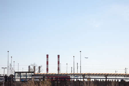 BELGRADE, SERBIA - APRIL 2, 2018: Train station of Novi Beograd, a suburban multimodal public transportation hub, a train passing by while industrial chimneys are in background.Picture of a train entering the suburban station of Novi Beograd, in Belgradのeditorial素材
