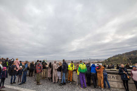 PRAGUE, CZECHIA - NOVEMBER 2, 2019: Crowd of tourists, packed, observing an aerial panorama of...