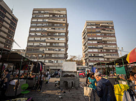 BELGRADE, SERBIA - OCTOBER 19, 2019: Panorama of the Kalenic pijaca market with poor sellers passing...