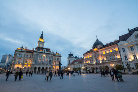NOVI SAD, SERBIA - NOVEMBER 26, 2016: Trg Slobode Square with the city hall, or Gradska Kuca, crowded, in novi sad, second biggest city of Serbia, at dusk.のeditorial素材