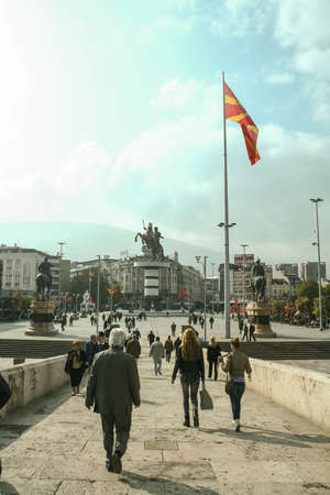 SKOPJE, MACEDONIA - OCTOBER 25, 2011: Crowd of Macedonian people going down the stone bridge to the Alexander the Great statue on Skopje's main square, one of the landmarks of the city.のeditorial素材