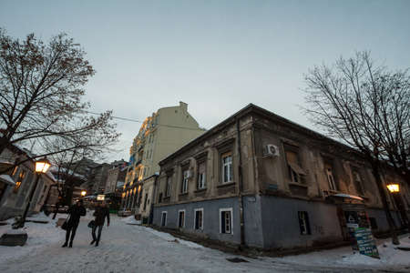BELGRADE, SERBIA - JANUARY 27, 2019: Skadarlija street (also known as Skadarska) in winter under the snow with its typical cobblestone pavement cafes and restaurants and tourists passing by.のeditorial素材