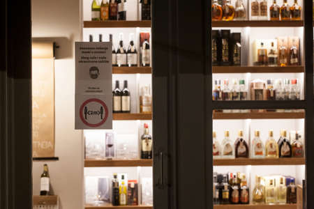 BELGRADE, SERBIA - OCTOBER 5, 2020: Entrance of a groceries store with two signs indicating social distancing and wearing facemask are mandatory inside the shop.のeditorial素材