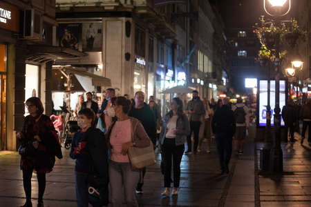 BELGRADE, SERBIA - OCTOBER 2, 2020: Family, a mother, woman, and her son, boy, walking wearing face mask protective equipment.のeditorial素材