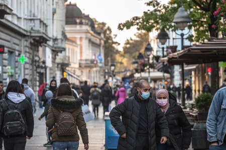 BELGRADE, SERBIA - OCTOBER 10, 2020: Couple, arabic middle eastern, with a woman with an islamic scarf veil walking in a Belgrade street.のeditorial素材