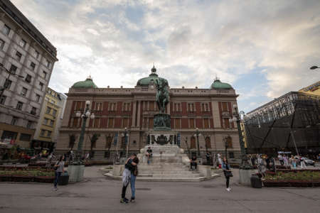 BELGRADE, SERBIA - JULY 19, 2018: Lovers kissing on Trg Republike, or Republic square with Prince Mihailo (Knez Mihailo) statue in front of National Museum of Serbia, also called Kod Konja.のeditorial素材