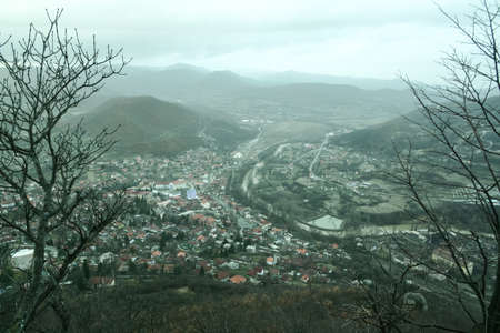 Panorama of the city of Zvecan, in the northern part of Kosovo, with a serb majority of population, in winter, with the mountain range of Ibarski Kolasin and the ibar river.のeditorial素材