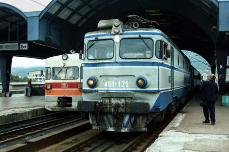 SKOPJE, MACEDONIA - SEPTEMBER 19, 2009: Passenger trains, DMU 712 and Electric locomotive 461 class...