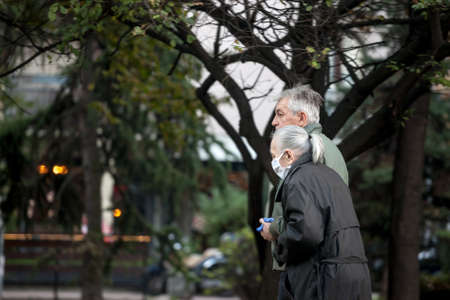 BELGRADE, SERBIA - NOVEMBER 8, 2020: Old senior man and woman, couple, wearing a respiratory face...
