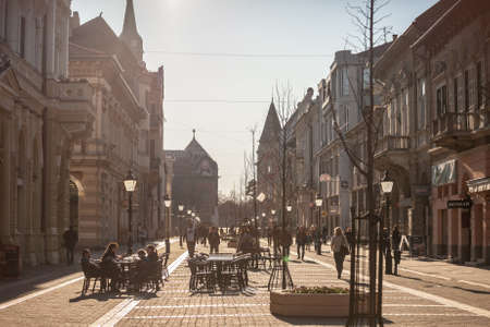 SUBOTICA, SERBIA - MARCH 28, 2019: People walking and sitting on the pedestrian street of Korzo, the main avenue of the center of Subotica, one of the main cities of Voivodina province.のeditorial素材