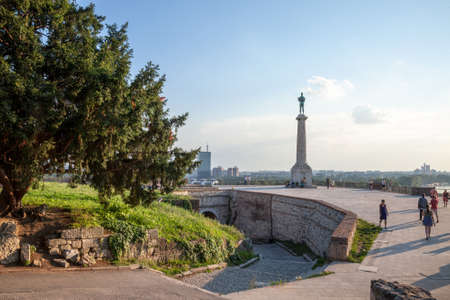 BELGRADE, SERBIA - JULY 11, 2018: Tourists standing in front of Victor statue on Kalemegdan fortress, during a sunny afternoon. Located in Kalemegdan fortress, it's a landmark of the city.のeditorial素材