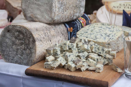 PARIS, FRANCE - JULY 12, 2019: Fourme d'Ambert cheese sliced on display on a table. Fourme dambert is a typical blue cheese from the Auvergne region produced around Ambert.のeditorial素材