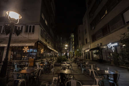 BELGRADE, SERBIA - DECEMBER 10, 2020: Empty terrace and patio of a bar restaurant at night closed...