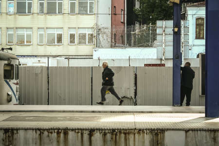 ISTANBUL, TURKEY - DECEMBER 26, 2009: Old turkish man running with a speed blur rushing to catch his commuter train in Sirkeci Gar train station, one of the main terminals of Istanbul.のeditorial素材