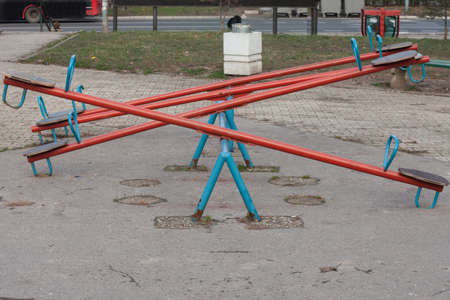 Close up on an empty children see saw, or teeter totter in a playground, with nobody. This type of...