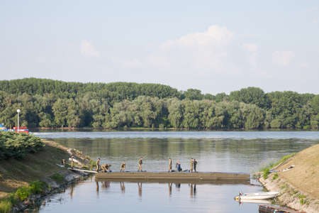 VUKOVAR, CROATIA - MAY 11, 2018: Croatian soldiers, infantry, in of Vukovar during training maneuvers on the Danube river facing Croatia Serbia border. Also called hrvatska vojska, or hv, it's the armed forces.のeditorial素材
