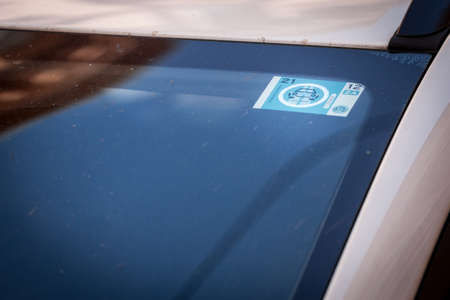 LJUBLJANA, SLOVENIA - JUNE 14, 2021: Selective blur on a slovenian vinjeta, also called vignette, on the windshield of a car in slovenia. This vignette is a tolling sticker used to pay toll for motorways.のeditorial素材