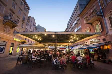 RIJEKA, CROATIA - JUNE 18, 2021: Croatian supporters in crowd at the terrace of a bar watching a football match of the Euro 2020 2021 with the Croatian Football team playing.のeditorial素材