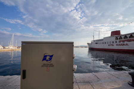 RIJEKA, CROATIA - JUNE 17, 2021: Logo of Lucka Uprava rijeka on one of their quays with ships in background. Called Port of Rijeka Authority, the administration manages the port of rijeka on Adriatic sea.のeditorial素材