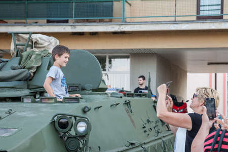 VUKOVAR, CROATIA - MAY 11, 2018: Kid, boy, young, being talekn in photo by his parents in an armored...