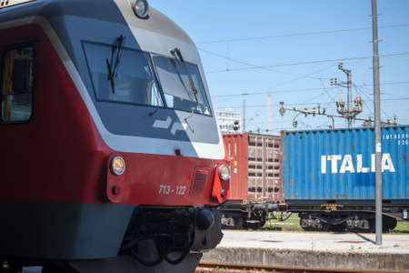 LJUBLJANA, SLOVENIA - JUNE 16, 2021: Slovenian Railways (Slovenske Zeleznice) diesel DMU Series 713 for a passenger service with a container cargo train behing shunting on Ljubljana train station.のeditorial素材