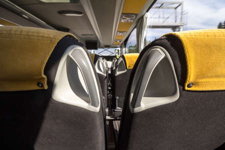 Empty bus seat taken in an modern long distance coach bus, with nobody inside, on an intercity travel on a sunny afternoon.の写真素材
