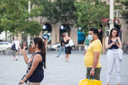 BELGRADE, SERBIA - JULY 12, 2021: Indian tourists, a couple of lovers, man and woman, young, from india, taking pictures in a belgrade street while traveling.のeditorial素材