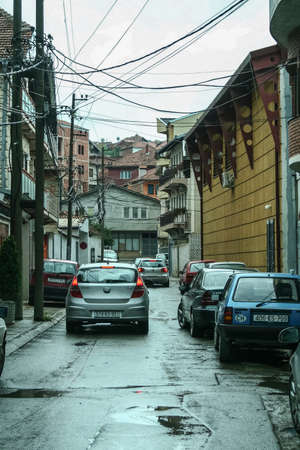 PRISHTINA, KOSOVO - SEPTEMBER 13, 2009: Cars chaotically parked in narrow street of dowtown prishtina, with typical turbo urbanization, an anarchic urban planning and development typical of Kosovo.のeditorial素材