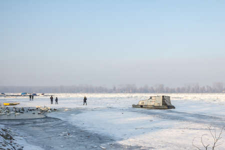 BELGRADE, SERBIA - JANUARY 21, 2017: People walking on Frozen Danube during 2017 winter, in Zemun with ice popping out of water. This winter was particularly harsh, paralyzing activity on the Danube.のeditorial素材