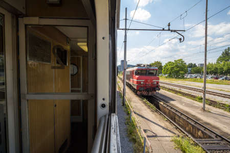 LJUBLJANA, SLOVENIA - JUNE 17, 2021: Slovenian Railways (Slovenske Zeleznice) electric locomotive Series 363 seen from window of 2nd class compartment of passenger on Ljubljana train station.のeditorial素材