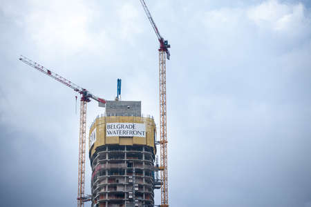 BELGARDE, SERBIA - APRIl 4, 2021: Construction site of Belgrade waterfront, or Beograd na vodi, with a focius on the beograd tower, or kula beograd. It is a controversed luxury real estate project.のeditorial素材