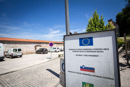 SKOFJA LOKA, SLOVENIA - JUNE 15, 2021: Sign promoting a reconstruction project funded by the European Union in Slovenia. The EU is one of the main funding donor in Balkans.のeditorial素材