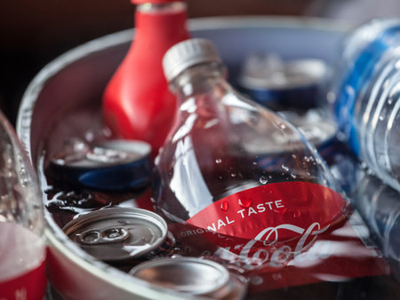 BELGRADE, SERBIA - JULY 31, 2021: Selective blur on Coca Cola on a bottle, ice cold in water. Coca Cola is a soda brand of cola, the most sold in the world, and a major american symbol.のeditorial素材