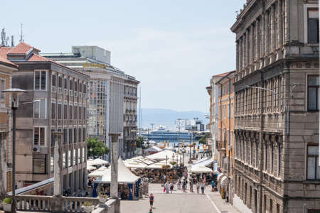 RIJEKA, CROATIA - JUNE 18, 2021: Typical street of the city center of Rijeka, with stairs and large pedestrian square of residential buildings by the waterfront of the adriatic sea. Rijeka is the main city of istria.のeditorial素材