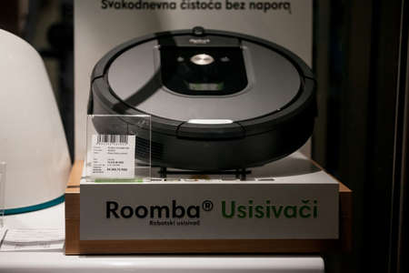 BELGRADE, SERBIA - OCTOBER 31, 2021: Selective blur on iRobot logo in front of a roomba vacuum...