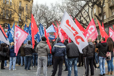 SUBOTICA, SERBIA - MARCH 27, 2016: Supporters of the Serbian Socialist part cheering and waiving their red flags in a political meeting. Called SPS or Socijalisticka partija srbije, it is the main left wing party of Serbia.のeditorial素材