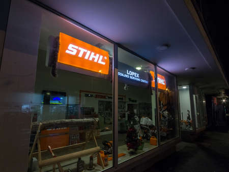 BELGRADE, SERBIA - DECEMBER 23, 2018: Selective blur on a Logo of Stihl in front of one of their retailer at night. Stihl is a german tool manufacturer specialized in chainsaw and handheld equipment.のeditorial素材