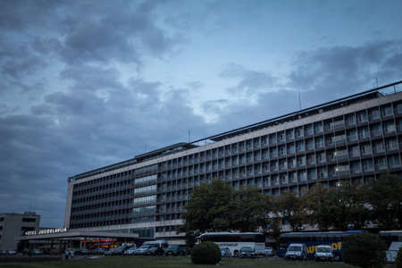 BELGRADE, SERBIA - OCTOBER 2, 2016: Main facade of hotel Jugoslavia, in Novi beograd district, a decaying socialist hotel from the Yugoslav era, during a cloudy afternoon.のeditorial素材