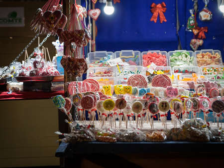 BELGRADE, SERBIA - DECEMBER 4, 2021: Selective blur on a stand of Belgrade christmas market selling Candies, candy sticks, sweets and lollilpops, diversified, display in loose.のeditorial素材